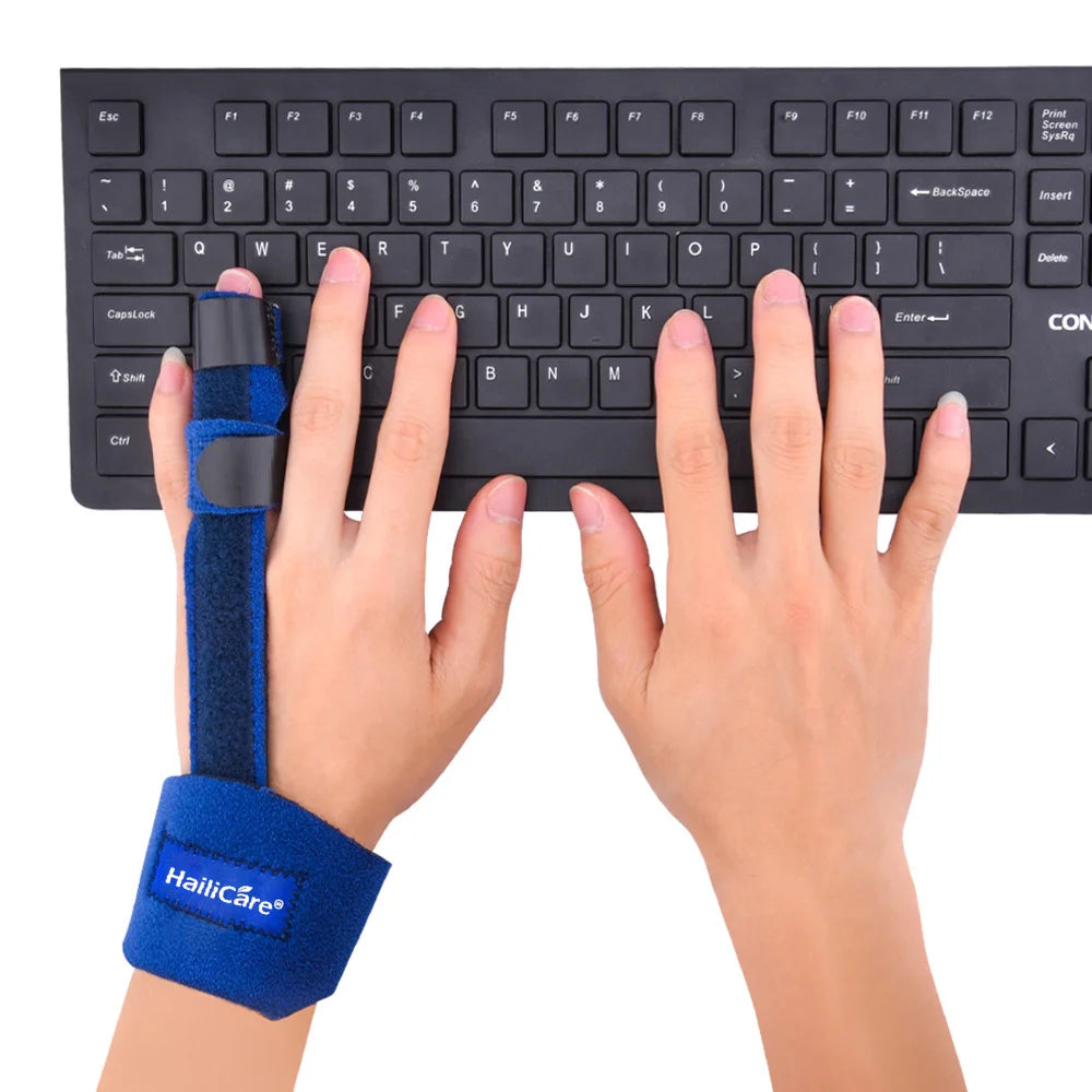 Blue thumb guard brace on hand while typing